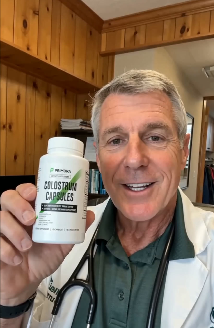 A bottle of Primora Colostrum Capsules held up to camera.